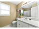 Well-lit bathroom features a large mirror, white vanity, and coordinated accessories at 3157 Brooks Dr, Snellville, GA 30078