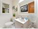 Bathroom featuring a framed mirror, framed art, a patterned accent lamp and a white sink at 3157 Brooks Dr, Snellville, GA 30078