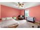 Cozy bedroom with pink walls, a round chair, and a crib, perfect for a Bedroom at 3157 Brooks Dr, Snellville, GA 30078