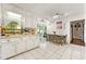 Well-lit kitchen boasts white cabinetry, tile flooring, and a dining area with sliding door access at 3157 Brooks Dr, Snellville, GA 30078