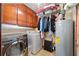 Functional laundry room with washer, dryer, cabinets, and water heater for convenience at 3157 Brooks Dr, Snellville, GA 30078
