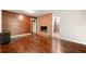 Spacious living room boasting hardwood floors, wood-paneled wall, and brick fireplace feature at 3157 Brooks Dr, Snellville, GA 30078