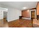 Open living room featuring hardwood floors, wood-paneled accent wall, and a brick fireplace at 3157 Brooks Dr, Snellville, GA 30078