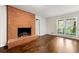 Bright living room with hardwood floors, a brick fireplace, and large windows at 3157 Brooks Dr, Snellville, GA 30078