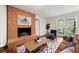 Cozy living room with a brick fireplace, large windows, and comfortable seating area at 3157 Brooks Dr, Snellville, GA 30078