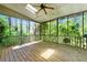 Screened-in porch with wood floors and ceiling fan, offering a relaxing outdoor space at 3157 Brooks Dr, Snellville, GA 30078