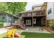 Backyard with deck, patio, gravel area, fire pit, and colorful play equipment at 342 5Th Ne St, Atlanta, GA 30308