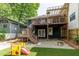 Exterior view of a home featuring a deck, and artificial turf backyard with fire pit at 342 5Th Ne St, Atlanta, GA 30308