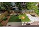 Landscaped backyard featuring artificial turf, stone patio, and play area, perfect for entertaining at 342 5Th Ne St, Atlanta, GA 30308