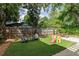 The fenced backyard features an artificial turf lawn, lounge seating and a patio area with a picnic table at 342 5Th Ne St, Atlanta, GA 30308