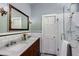 Modern bathroom features a double sink vanity, white subway tiles and glass enclosed shower at 342 5Th Ne St, Atlanta, GA 30308