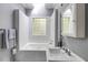 Bathroom featuring a soaking tub, glass block window, and a traditional sink with decorative fixtures at 342 5Th Ne St, Atlanta, GA 30308