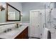 Elegant bathroom features a double sink vanity with marble countertop and a glass-enclosed shower at 342 5Th Ne St, Atlanta, GA 30308