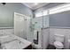 Updated bathroom with tile shower, glass door, and double sink vanity with modern fixtures at 342 5Th Ne St, Atlanta, GA 30308