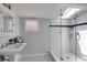 Bright bathroom with glass shower, skylight, and black and white tiled floors at 342 5Th Ne St, Atlanta, GA 30308