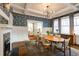 Well-lit dining room with a large table, patterned wallpaper, and stylish modern lighting at 342 5Th Ne St, Atlanta, GA 30308