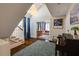 Bright foyer with a chandelier, staircase and blue rug at 342 5Th Ne St, Atlanta, GA 30308