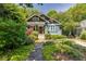 Charming craftsman-style home with blue exterior, inviting front porch, and beautiful landscaping at 342 5Th Ne St, Atlanta, GA 30308