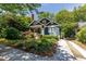 Charming craftsman-style home with blue exterior, inviting front porch, driveway and lush landscaping at 342 5Th Ne St, Atlanta, GA 30308