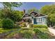 Charming craftsman-style home with blue exterior, inviting front porch, and lush landscaping at 342 5Th Ne St, Atlanta, GA 30308