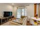 A comfy living room with a sofa, television, and a small table near a large sliding door at 342 5Th Ne St, Atlanta, GA 30308