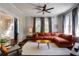 Bright living room featuring a large sectional sofa, ceiling fan, and natural light at 342 5Th Ne St, Atlanta, GA 30308