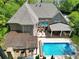 Aerial view of house with in-ground pool, wood pergola dining area, and brick construction at 3590 Fricks Rd, Marietta, GA 30062