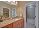 Bathroom with granite countertop, wood cabinets, and doorway to the tub at 3590 Fricks Rd, Marietta, GA 30062