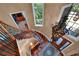 Elegant foyer with curved staircase, chandelier, and hardwood floors at 3590 Fricks Rd, Marietta, GA 30062