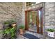Inviting front entryway with brick facade, decorative glass door, and potted plants at 3590 Fricks Rd, Marietta, GA 30062