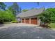 Spacious three-car garage with brick exterior and ample driveway space at 3590 Fricks Rd, Marietta, GA 30062