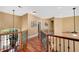 Upstairs hallway with hardwood floors and decorative wrought iron railing at 3590 Fricks Rd, Marietta, GA 30062