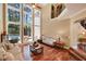 Beautiful living room with large windows overlooking the backyard and an adjacent staircase leading to a second floor at 3590 Fricks Rd, Marietta, GA 30062