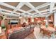 Open-concept living area features coffered ceilings, fireplace, and seamless flow to the kitchen at 3590 Fricks Rd, Marietta, GA 30062