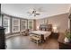 Spacious primary bedroom with wood-look tile, a ceiling fan, and large windows at 3590 Fricks Rd, Marietta, GA 30062