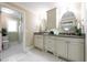 Bathroom featuring a dual vanity with oval mirrors, cabinetry, and a separate shower stall at 1440 Hillpine Ln, Atlanta, GA 30306