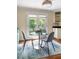 Cozy breakfast nook with a round glass table and access to the outdoors through bright, glass-paned doors at 1440 Hillpine Ln, Atlanta, GA 30306