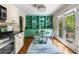 Charming breakfast nook adjacent to the kitchen, featuring a round table and a door leading to a balcony at 1440 Hillpine Ln, Atlanta, GA 30306