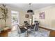 Airy dining room with a glass table, modern decor, and abundant natural light streaming through nearby windows at 1440 Hillpine Ln, Atlanta, GA 30306