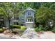 Charming townhome with gray siding, inviting front yard, and attached garage at 1440 Hillpine Ln, Atlanta, GA 30306