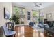 Bright living room featuring hardwood floors, a fireplace, and large windows at 1440 Hillpine Ln, Atlanta, GA 30306