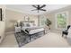 Sun-lit bedroom with accent rug under bed, refined furnishings, and leafy tree just outside the windows at 1440 Hillpine Ln, Atlanta, GA 30306