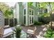 Covered patio with outdoor seating, lush plants, and verdant trees at 1440 Hillpine Ln, Atlanta, GA 30306