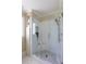 Elegant glass-enclosed shower with subway tile, built-in niche, seating, and modern shower head at 1440 Hillpine Ln, Atlanta, GA 30306