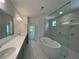 Stunning bathroom featuring a soaking tub, frameless shower, and dual sink vanity at 1994 Freestone Way, Marietta, GA 30064