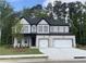 Charming two-story home featuring a brick exterior, a well-manicured lawn and an attached garage at 1994 Freestone Way, Marietta, GA 30064