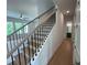 Staircase with wooden handrail and black metal balusters leading to the upper level at 1994 Freestone Way, Marietta, GA 30064