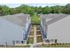 An aerial view of modern townhomes with sidewalks and well-manicured landscaping and lush green grass at 2110 Prichard Park Dr, Kennesaw, GA 30144