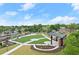 Aerial view of a large green space with an outdoor stage, surrounded by trees and buildings in a neighborhood at 2110 Prichard Park Dr, Kennesaw, GA 30144