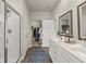 Clean bathroom with double sinks, framed mirrors, walk-in closet, and a modern glass enclosed shower at 2110 Prichard Park Dr, Kennesaw, GA 30144